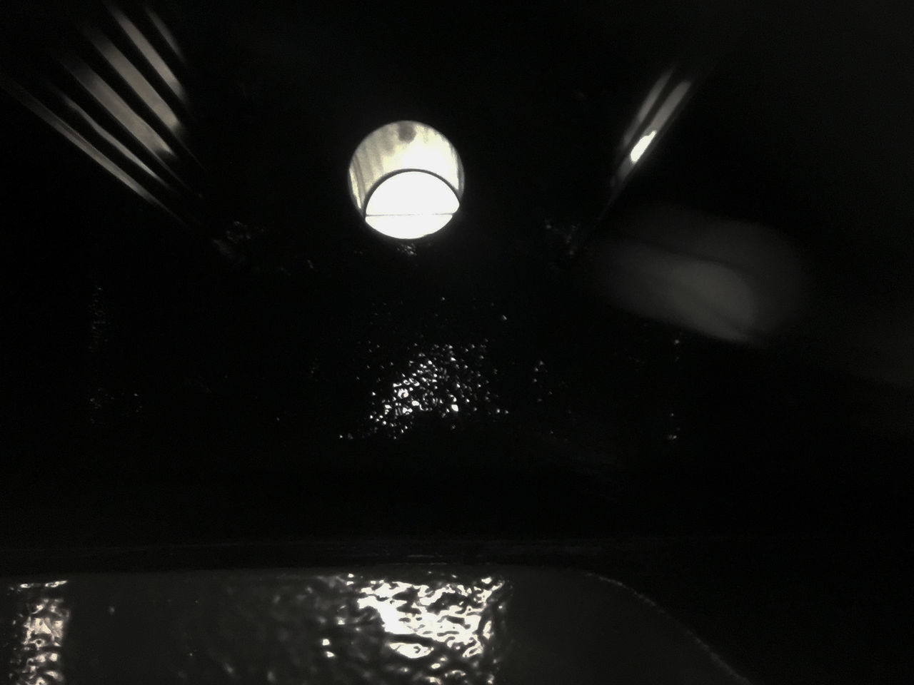 LOW ANGLE VIEW OF ILLUMINATED WATER IN TANK