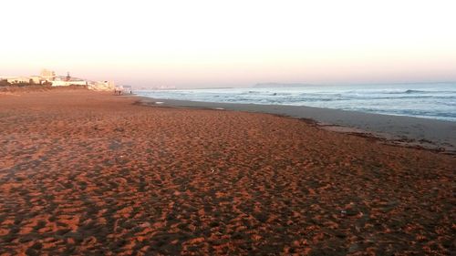 Scenic view of beach against clear sky