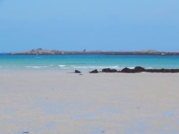 Scenic view of sea against blue sky