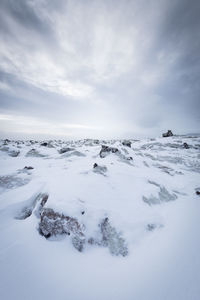 Scenic view of snow covered landscape against sky