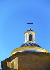 Low angle view of building against clear blue sky