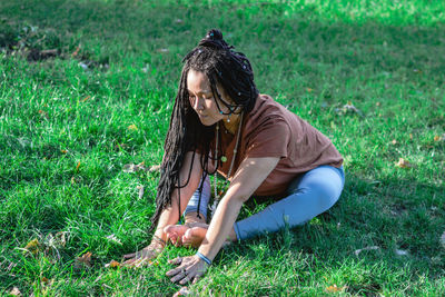 Beautiful young woman is doing yoga outside in a park. concept of healthy lifestyle.