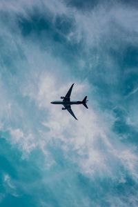 Low angle view of airplane flying in sky