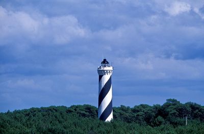 St giron lighthouse amidst trees against sky