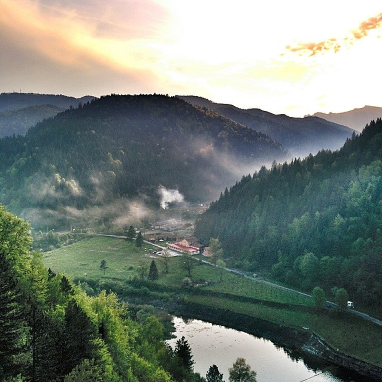 mountain, tranquil scene, tree, tranquility, scenics, beauty in nature, landscape, sky, water, nature, mountain range, river, sunset, non-urban scene, high angle view, cloud - sky, idyllic, reflection, lake, growth