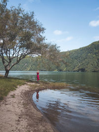 Woman standing by lake