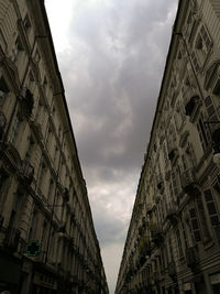 Low angle view of building against cloudy sky