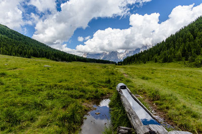 Wooden fountain on the valley in san martino di castrozza trento italy