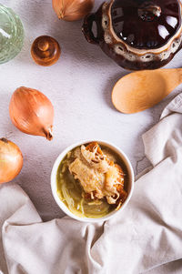 French onion soup with baked cheese bread in a bowl on the table top and vertical view