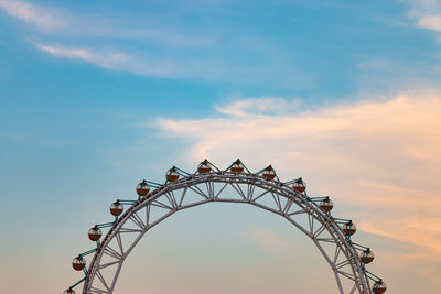 Low angle view of ferris wheel against sky during sunset