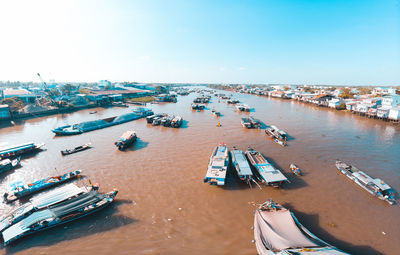 High angle view of boats moored at harbor against sky