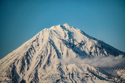 Scenic view of snowcapped mountains against clear blue sky