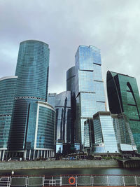 Low angle view of modern buildings against sky in city