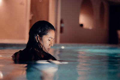 Portrait of woman relaxing in swimming pool