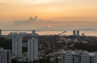 High angle view of buildings against sky during sunset