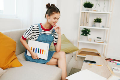 Young woman using digital tablet on table