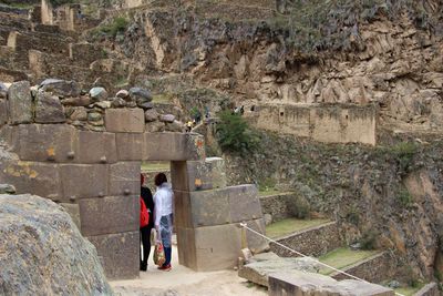 Rear view of people on inca ruins