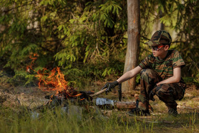 Rear view of man standing in forest