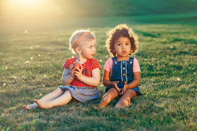 Happy friends sitting on land