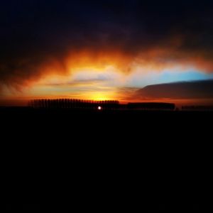 Silhouette of landscape against dramatic sky