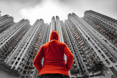 Rear view of man and woman standing against buildings