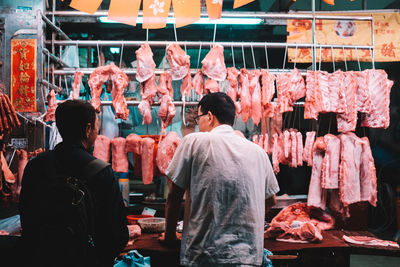 Rear view of people at market stall