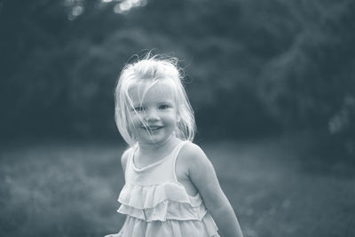 Portrait of cute girl standing outdoors