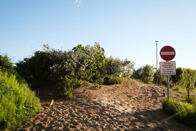 Road sign against clear sky