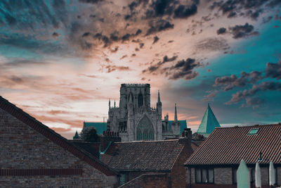 Buildings in city against sky during sunset