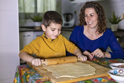 Portrait of a smiling girl having food in kitchen