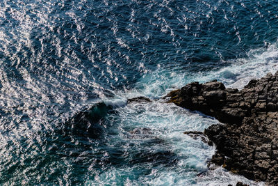 Sea waves splashing on rock