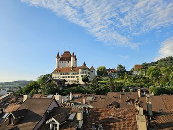 Buildings in town against sky