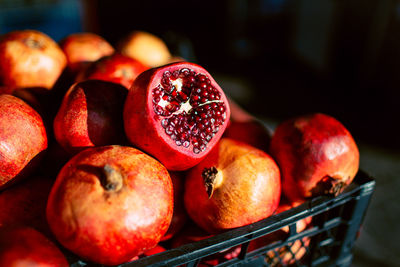 High angle close-up of pomegranates in crate for sale at market