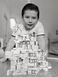 Portrait of boy with domino at home
