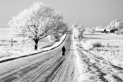 People walking on snow covered landscape