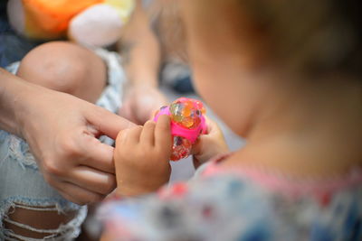 Close-up of hands holding girl