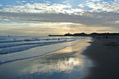 Scenic view of beach against sky during sunset