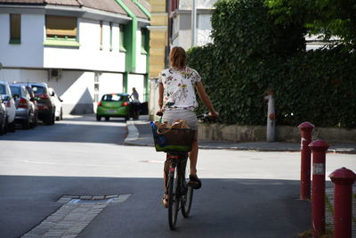 Rear view of woman riding bicycle