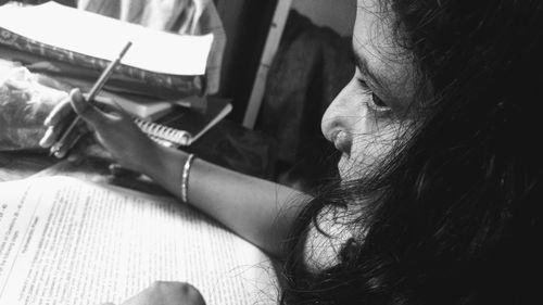 Close-up portrait of woman sitting at home