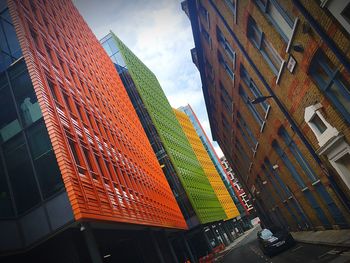 Low angle view of buildings in city against sky