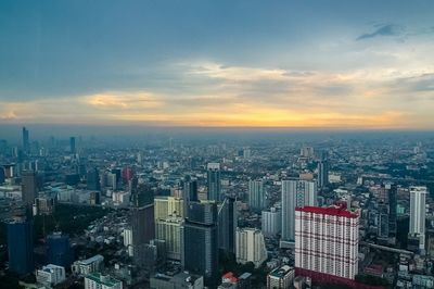 High angle view of modern buildings against sky during sunset