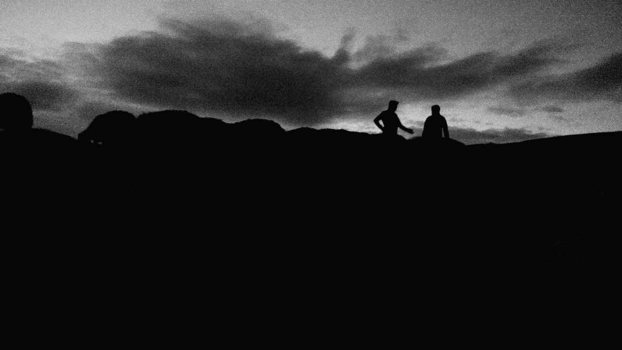 silhouette, sky, cloud, tranquility, tranquil scene, outline, dark, scenics, mountain, nature, solitude, calm, outdoors, beauty in nature, remote, black and white, cloud - sky, escapism, moody sky, non-urban scene