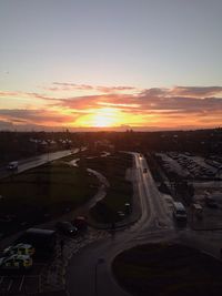 High angle view of vehicles on road at sunset