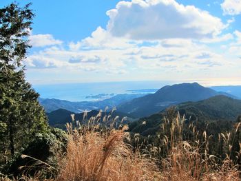 Scenic view of mountains against cloudy sky