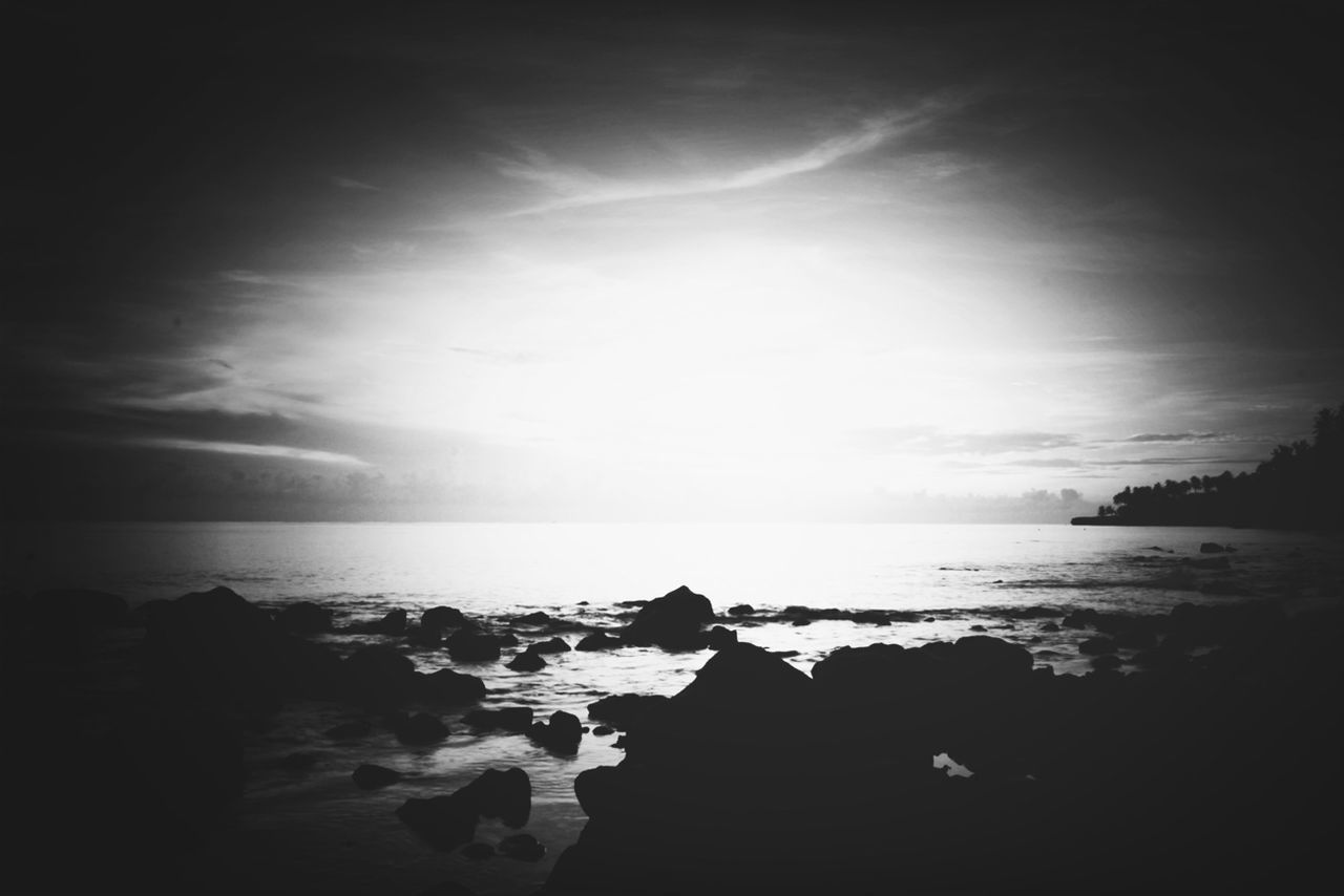 sea, water, horizon over water, rock - object, sky, scenics, tranquility, tranquil scene, silhouette, beauty in nature, sunset, nature, shore, beach, sun, idyllic, rock formation, sunlight, cloud - sky, outdoors