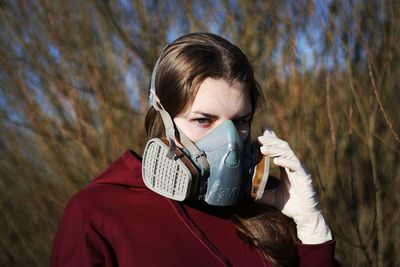 Portrait of woman wearing gas mask