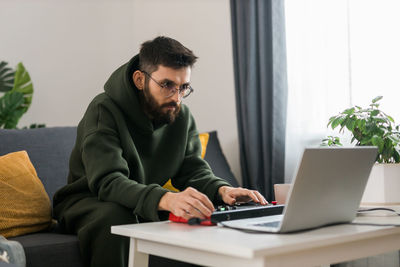 Young man using laptop at home