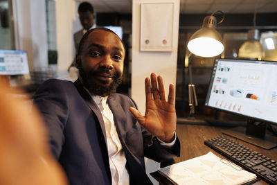 Portrait of businessman using mobile phone in office