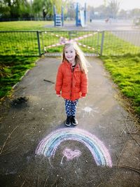 Full length of woman standing on footpath