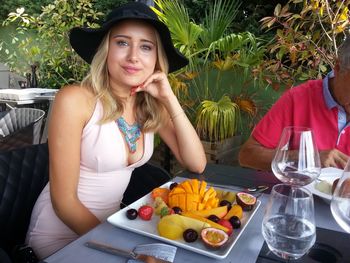 Portrait of beautiful woman sitting at cafe